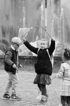 Joyful children blowing bubbles in the square of Wrocław, Poland, capturing a playful moment.