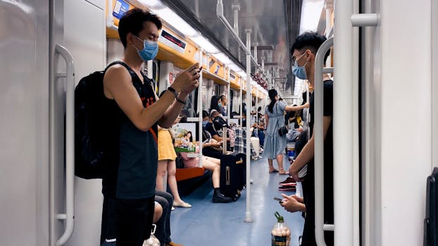 Passengers wearing masks on Guangzhou subway, capturing daily transit life.